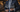 Confident professional man in a tailored navy suit preparing for an important meeting or presentation