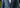 a man in a tailored navy suit walking confidently