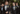Raleigh groomsmen wearing black tuxedos with satin lapels and boutonnieres at an outdoor wedding in Raleigh NC